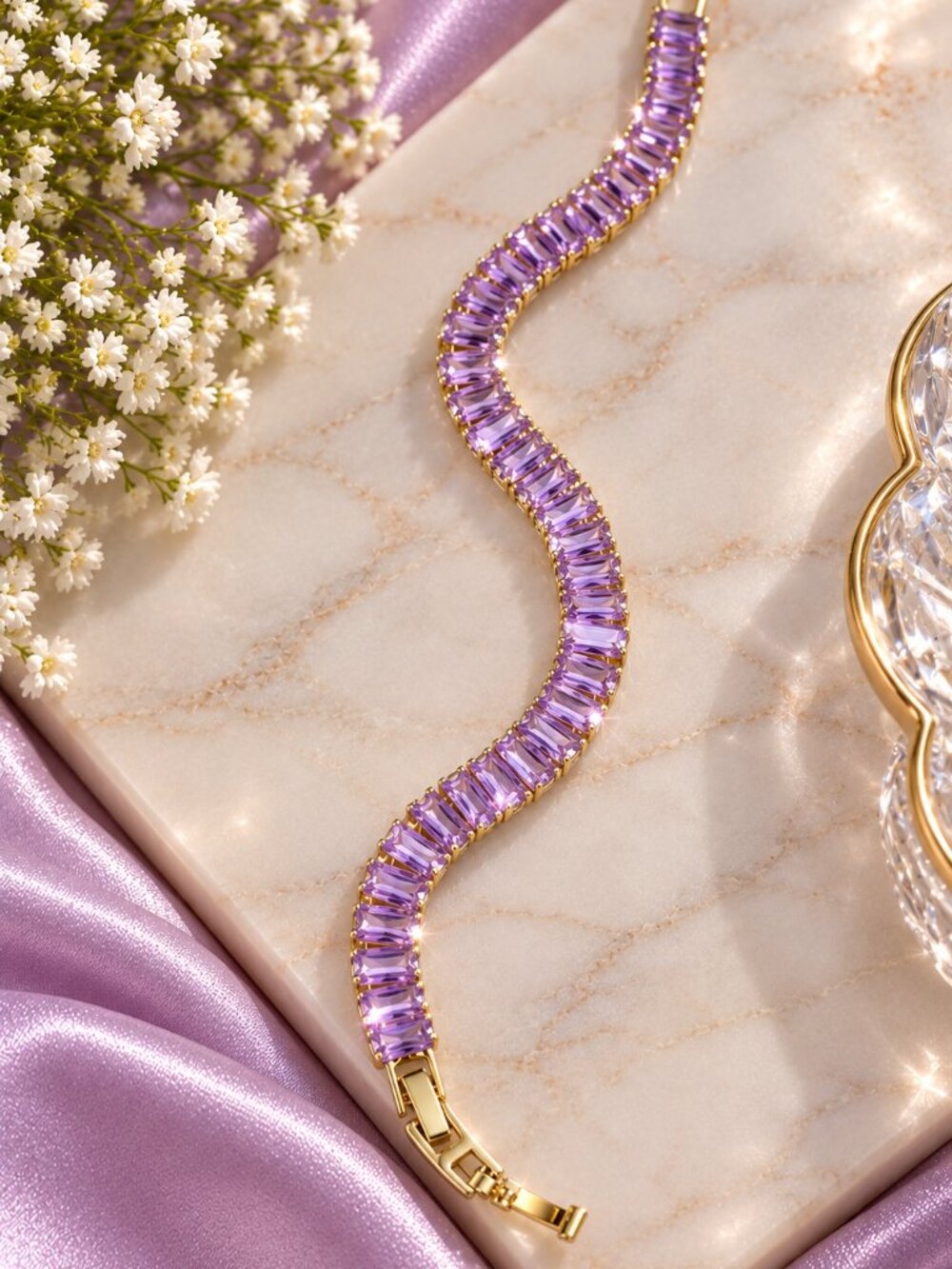 Gold-tone bracelet featuring sparkling light-purple baguette-cut crystals